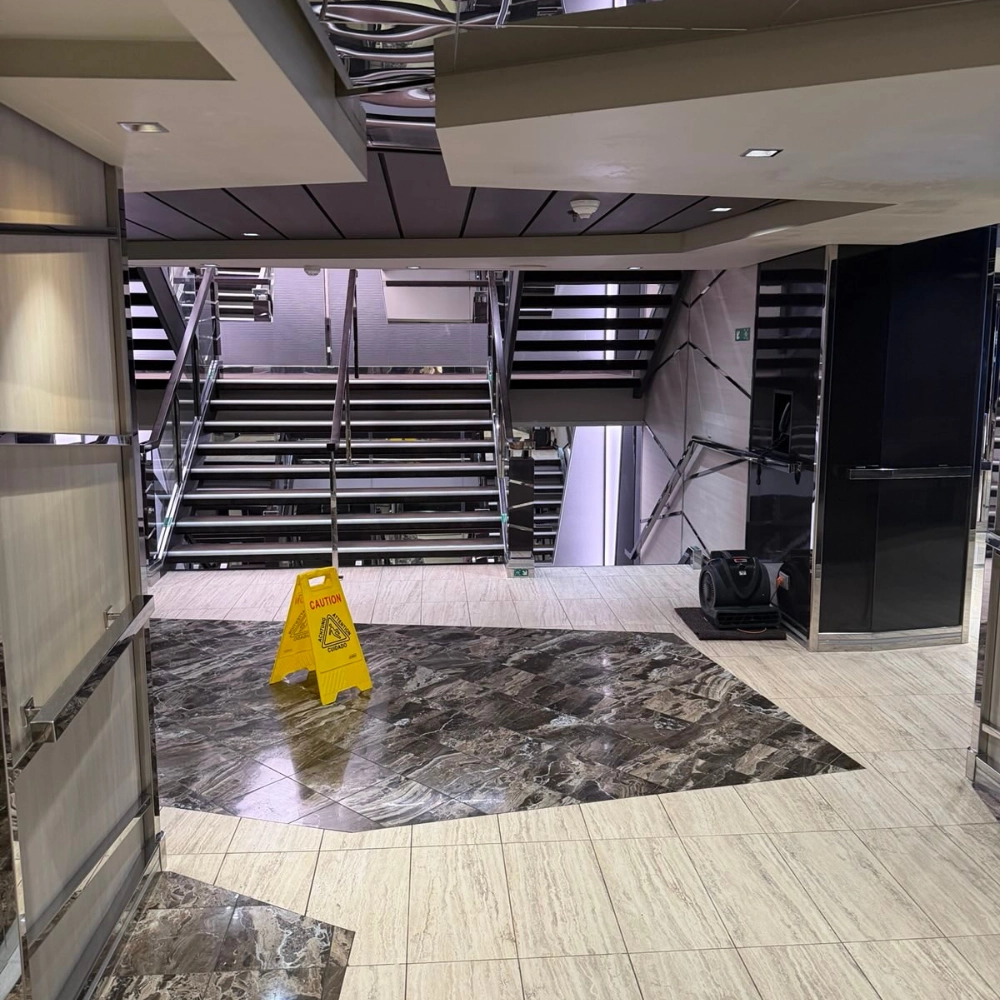 stairs with wet floor sign