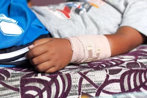 boy on bed with cast around arm
